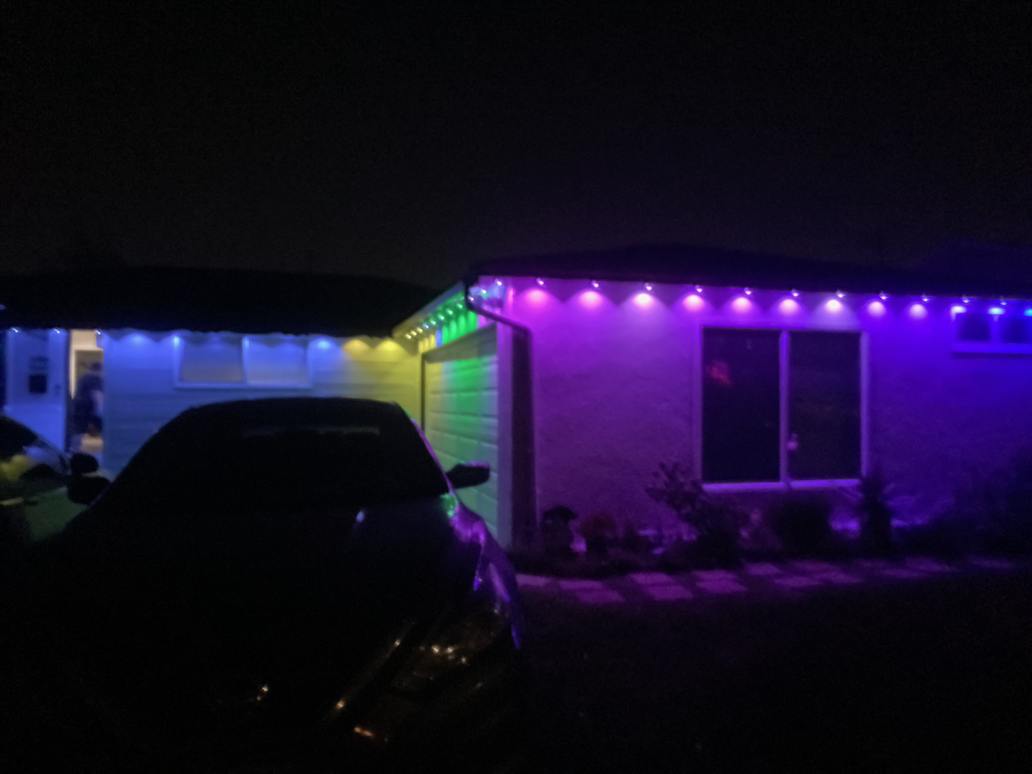 Purple and green outdoor lighting on a home